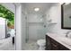 Updated bathroom with a tiled shower, marble counters and access to a lush backyard at 3029 Peel Ave, Orlando, FL 32806