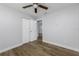 Neutral bedroom featuring wood flooring, closet, and access to another room at 3029 Peel Ave, Orlando, FL 32806