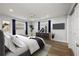 Staged bedroom featuring modern decor, an area rug, and wood flooring at 3029 Peel Ave, Orlando, FL 32806