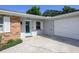 Charming home exterior featuring a light blue front door, attached garage, and well-maintained landscaping at 3029 Peel Ave, Orlando, FL 32806