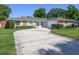 Well-maintained single-story brick home with a long driveway and manicured front lawn at 3029 Peel Ave, Orlando, FL 32806