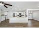 Modern kitchen with stainless steel appliances, white cabinetry, and large breakfast bar seating at 3029 Peel Ave, Orlando, FL 32806