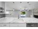 Stylish kitchen featuring marble countertops and a view of the backyard pool area at 3029 Peel Ave, Orlando, FL 32806