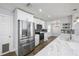 Bright kitchen with stainless steel appliances, white cabinets, granite countertops, and modern fixtures at 3029 Peel Ave, Orlando, FL 32806