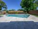 Backyard pool with a travertine deck, an in-pool lounge float and mature landscaping at 3029 Peel Ave, Orlando, FL 32806