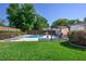 Beautiful backyard featuring a pool, lounge chairs, and covered outdoor dining area with lush green grass and landscaping at 3029 Peel Ave, Orlando, FL 32806