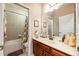 Cozy bathroom showcasing a tiled shower and bath combination and warm cabinets at 310 Stakes Ct, Deland, FL 32724