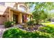 Home exterior showcasing a landscaped garden and covered front porch entryway at 310 Stakes Ct, Deland, FL 32724