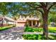 Charming home featuring a well-manicured lawn, mature trees, and a welcoming two-car garage at 310 Stakes Ct, Deland, FL 32724