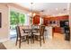 Eat-in kitchen with dark wood cabinets, tile floor, and access to the backyard pool at 310 Stakes Ct, Deland, FL 32724