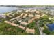 Aerial view of a community featuring lush landscaping, a pool, and a serene lakeside setting at 3542 Shallot Dr # 108, Orlando, FL 32835