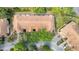 Aerial view showcases the townhome's tile roof and placement amidst lush green trees, highlighting its peaceful setting at 3542 Shallot Dr # 108, Orlando, FL 32835