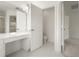 This bathroom showcases a spacious layout with an open door to an adjacent room and white tile flooring at 3542 Shallot Dr # 108, Orlando, FL 32835