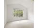A light filled room with neutral carpet features a large window at 3542 Shallot Dr # 108, Orlando, FL 32835