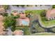 Aerial view of a community pool, with lounge chairs and green landscaping, next to a pond at 3542 Shallot Dr # 108, Orlando, FL 32835