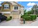 Attractive townhome with a tile roof, two-car garage, and well-manicured landscaping creating a welcoming exterior at 3542 Shallot Dr # 108, Orlando, FL 32835