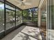 A screened lanai with no outdoor seating with a ceiling fan and views of the lush landscape at 3542 Shallot Dr # 108, Orlando, FL 32835