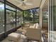 A screened lanai showcases outdoor seating with a ceiling fan and views of the lush landscape at 3542 Shallot Dr # 108, Orlando, FL 32835