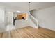 Open floor plan with wood flooring leads into kitchen with modern staircase at 3542 Shallot Dr # 108, Orlando, FL 32835