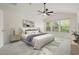 This bedroom is bright and open, featuring a ceiling fan and multiple windows offering serene views at 3542 Shallot Dr # 108, Orlando, FL 32835