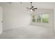 Bright bedroom featuring vaulted ceilings, a modern ceiling fan, and expansive windows filling the space with light at 3542 Shallot Dr # 108, Orlando, FL 32835