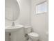 Neat powder room features a pedestal sink, toilet, and a window that fills the space with natural light at 3542 Shallot Dr # 108, Orlando, FL 32835