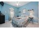 Bedroom featuring blue walls, tile floors, a ceiling fan, and a window with curtains at 392 Bayberry Dr, Polk City, FL 33868