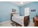 Bedroom with blue walls, tile floors, a ceiling fan, a window, and stylish decor at 392 Bayberry Dr, Polk City, FL 33868