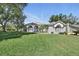 Charming one-story home with well-maintained lawn, mature trees, and architectural details at 392 Bayberry Dr, Polk City, FL 33868