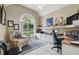 Cozy home office with a large arched window, built in shelving and cabinets at 392 Bayberry Dr, Polk City, FL 33868