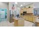 Bright kitchen with stainless steel refrigerator and center island cooktop at 392 Bayberry Dr, Polk City, FL 33868