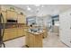 Bright kitchen with light wood cabinets and large center island at 392 Bayberry Dr, Polk City, FL 33868