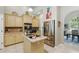 Bright kitchen with stainless steel refrigerator and direct access to formal dining area at 392 Bayberry Dr, Polk City, FL 33868