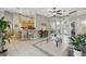 Open-concept living area with tile flooring, barstool seating, and view of kitchen at 392 Bayberry Dr, Polk City, FL 33868