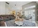 Open concept living room with tile floors, neutral colors and view into the dining room at 392 Bayberry Dr, Polk City, FL 33868