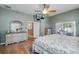 Well-lit main bedroom featuring a King bed, dresser, and access to private bathroom at 392 Bayberry Dr, Polk City, FL 33868