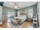 Main bedroom with King bed, ceiling fan, and access to outdoor seating area at 392 Bayberry Dr, Polk City, FL 33868