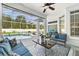 Spacious enclosed patio featuring comfortable seating, a view of the pool, and an outdoor garden at 392 Bayberry Dr, Polk City, FL 33868