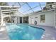Backyard view featuring a screened pool, a patio area, and a house exterior at 392 Bayberry Dr, Polk City, FL 33868