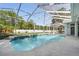 Screened-in pool area featuring a pool, a patio, and a well-maintained backyard at 392 Bayberry Dr, Polk City, FL 33868