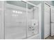 Bathroom featuring a white shower, tiled walls, sliding glass doors, and a showerhead at 392 Bayberry Dr, Polk City, FL 33868