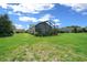 Large green backyard featuring a screened in porch at 4687 Nw 35Th Lane Rd, Ocala, FL 34482