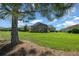 Home featuring a well-maintained backyard and screened in porch at 4687 Nw 35Th Lane Rd, Ocala, FL 34482