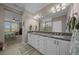 This bathroom features a double sink vanity, tile floors, and is attached to the main bedroom at 4687 Nw 35Th Lane Rd, Ocala, FL 34482
