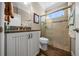 Bathroom with granite countertop vanity, tiled shower, and updated fixtures at 4687 Nw 35Th Lane Rd, Ocala, FL 34482