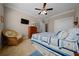 Charming bedroom with a cozy chair, dresser, and a bed featuring a blue and white quilt at 4687 Nw 35Th Lane Rd, Ocala, FL 34482