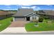 A beautiful home with lush green lawn, mature landscaping and a two-car garage at 4687 Nw 35Th Lane Rd, Ocala, FL 34482