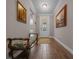 Elegant hallway featuring a decorative glass front door, bench seating, and stylish wood-look tile flooring at 4687 Nw 35Th Lane Rd, Ocala, FL 34482
