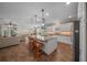 Open kitchen featuring a large center island, granite countertops, stainless appliances, and wood flooring at 4687 Nw 35Th Lane Rd, Ocala, FL 34482
