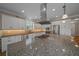 Modern kitchen with granite island, stainless appliances, and updated cabinetry at 4687 Nw 35Th Lane Rd, Ocala, FL 34482